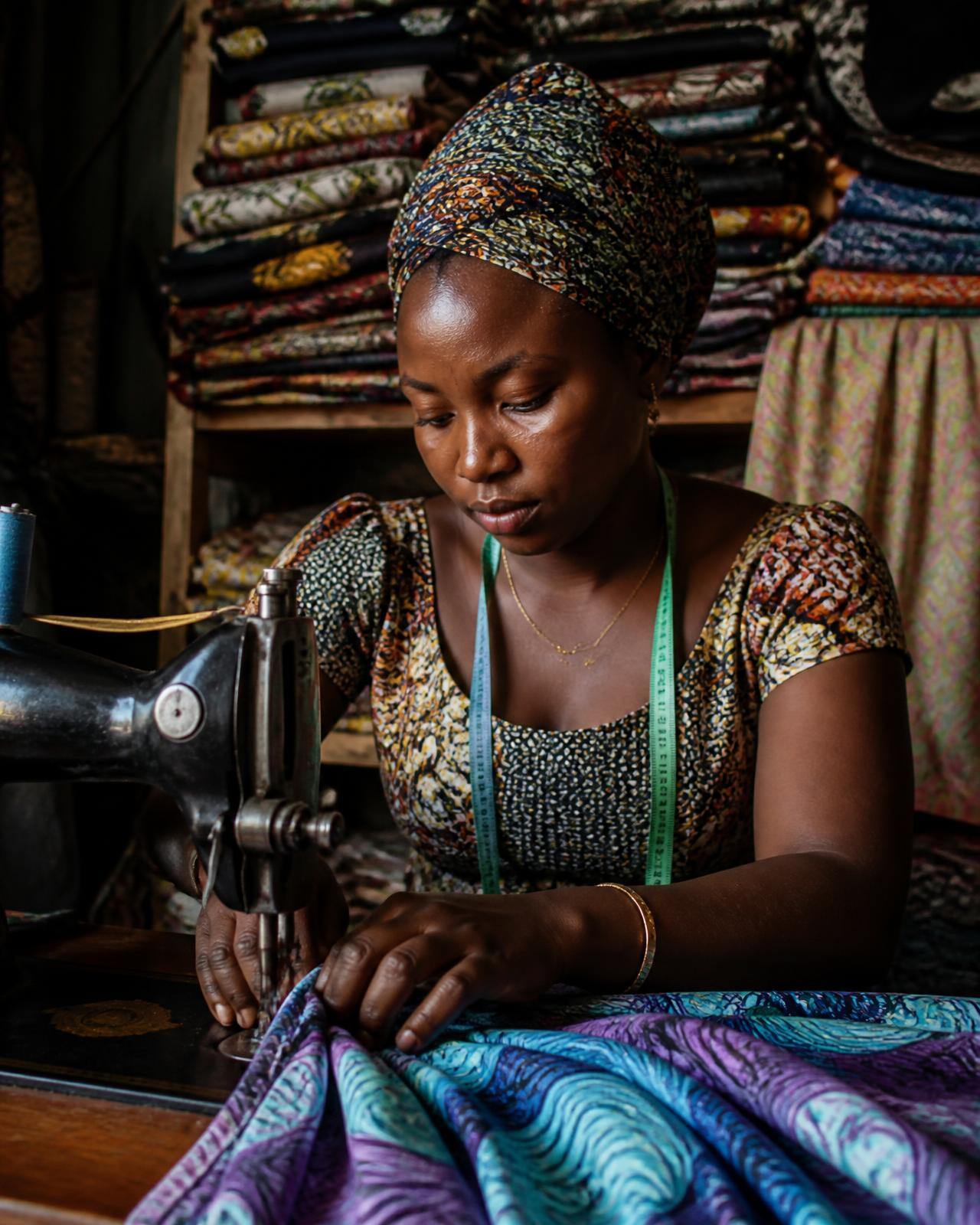 Nigerian textile entrepreneur working in her shop
